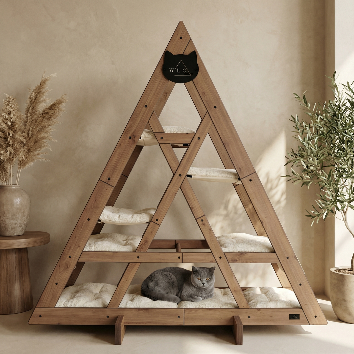 Wooden triangle-shaped pet bed with a cat inside, placed against a beige wall with decorative plants.
