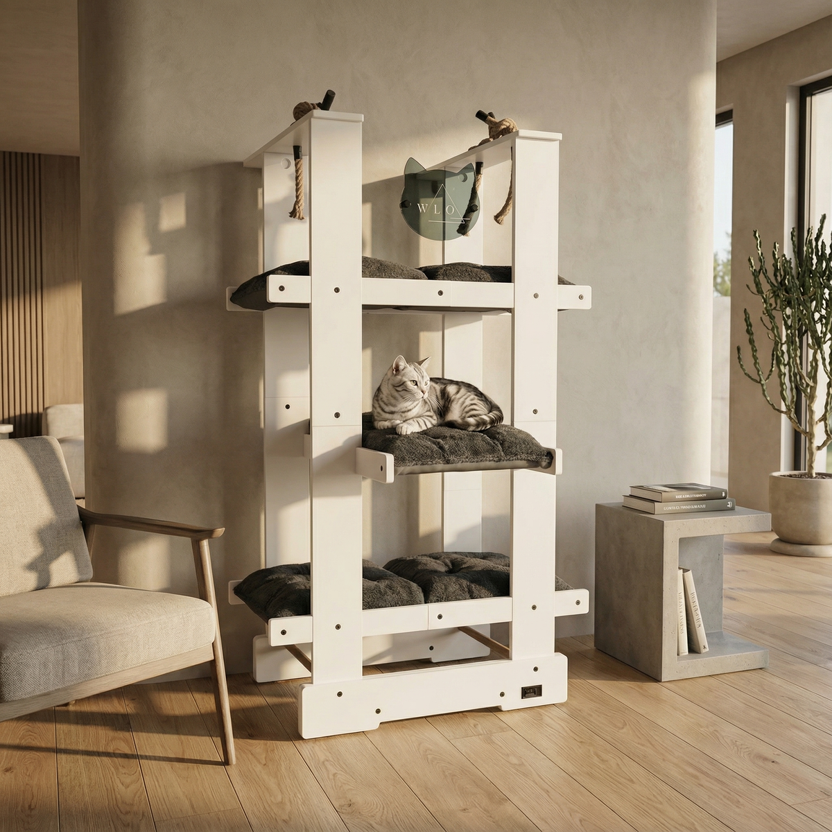 White cat tree with multiple levels and cushions in a room with a chair and plant.