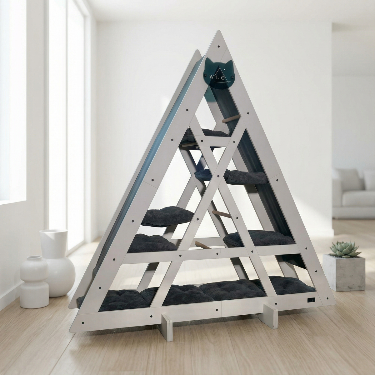 Triangular cat tree with multiple levels and cushions in a modern living room.