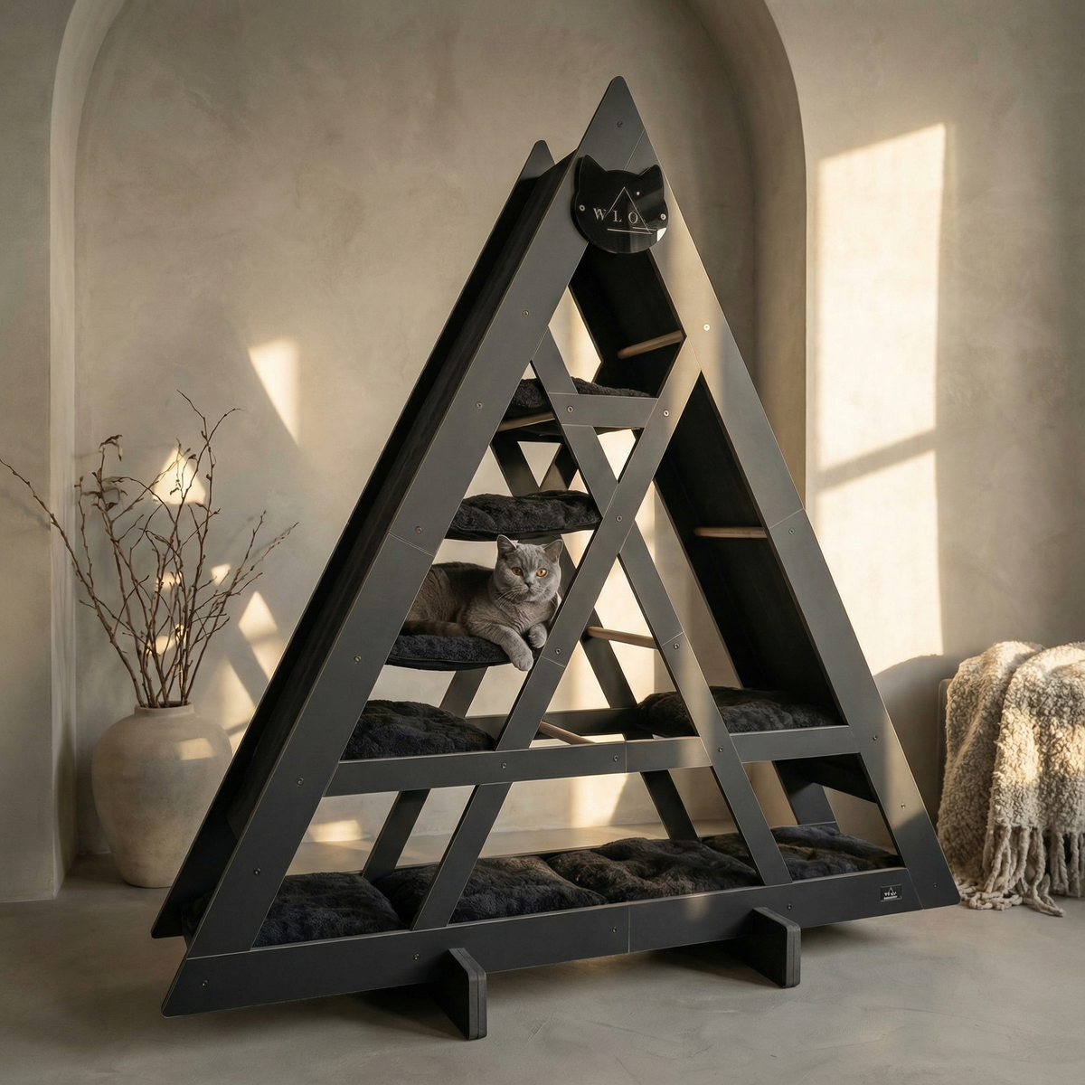Triangular cat tree with a cat sitting on it in a home setting