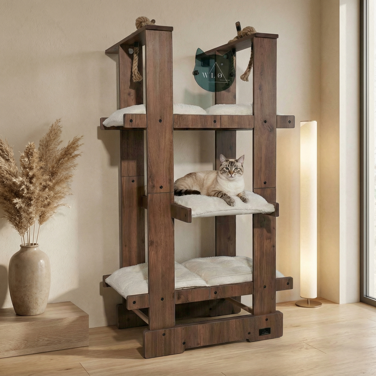 Wooden cat tree with a cat sitting on it in a room with a vase and lamp.