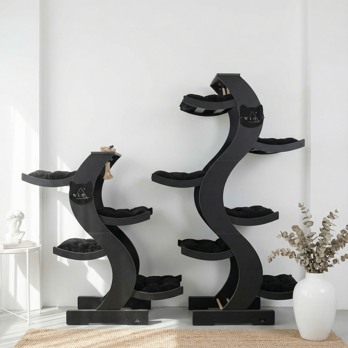 Black spiral cat tree with multiple levels on a white background