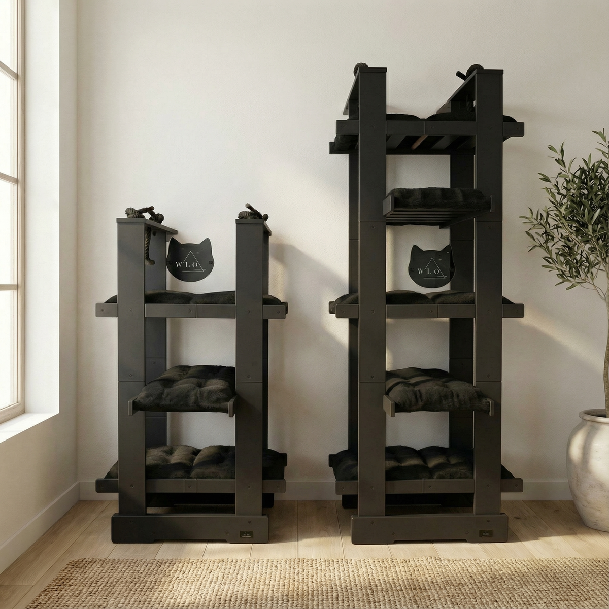 Two dark wooden cat trees with platforms and cushions in a room with a window and plant.