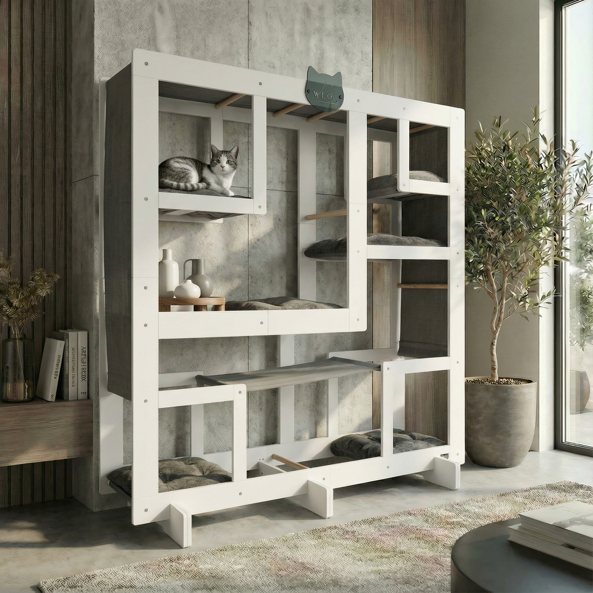 White cat tree with multiple levels and shelves in a room with a plant and books.